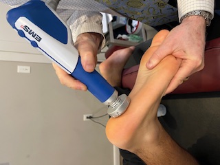 Shockwave (ESWT) therapy being applied to a patient's foot at DeFabio Chiropractic in Berkeley Heights, NJ